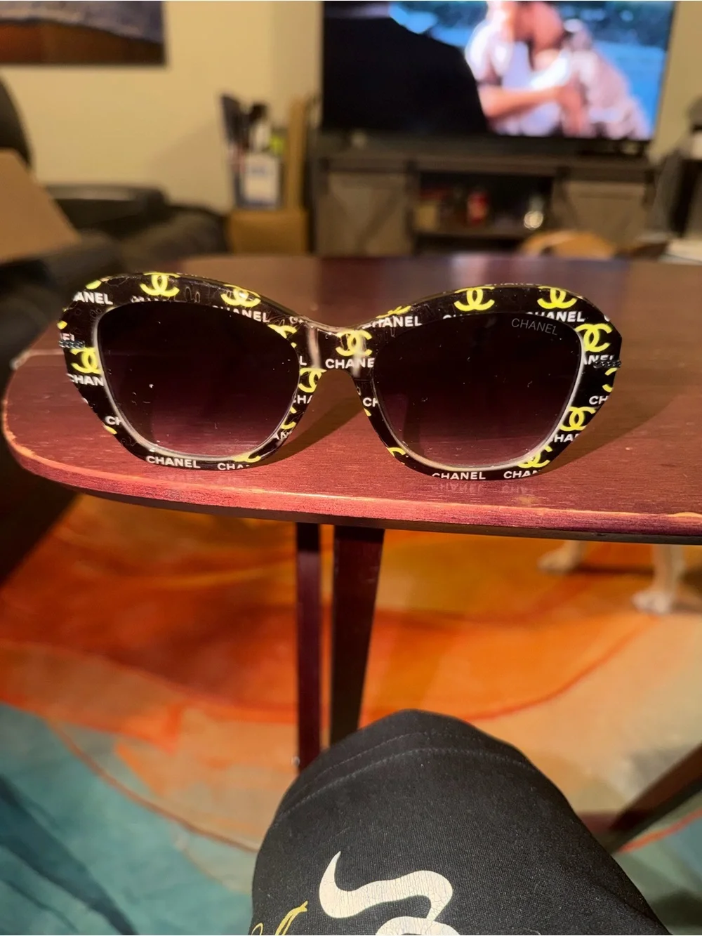 CHANEL Black Frame Sunglasses with Yellow Logo Accents